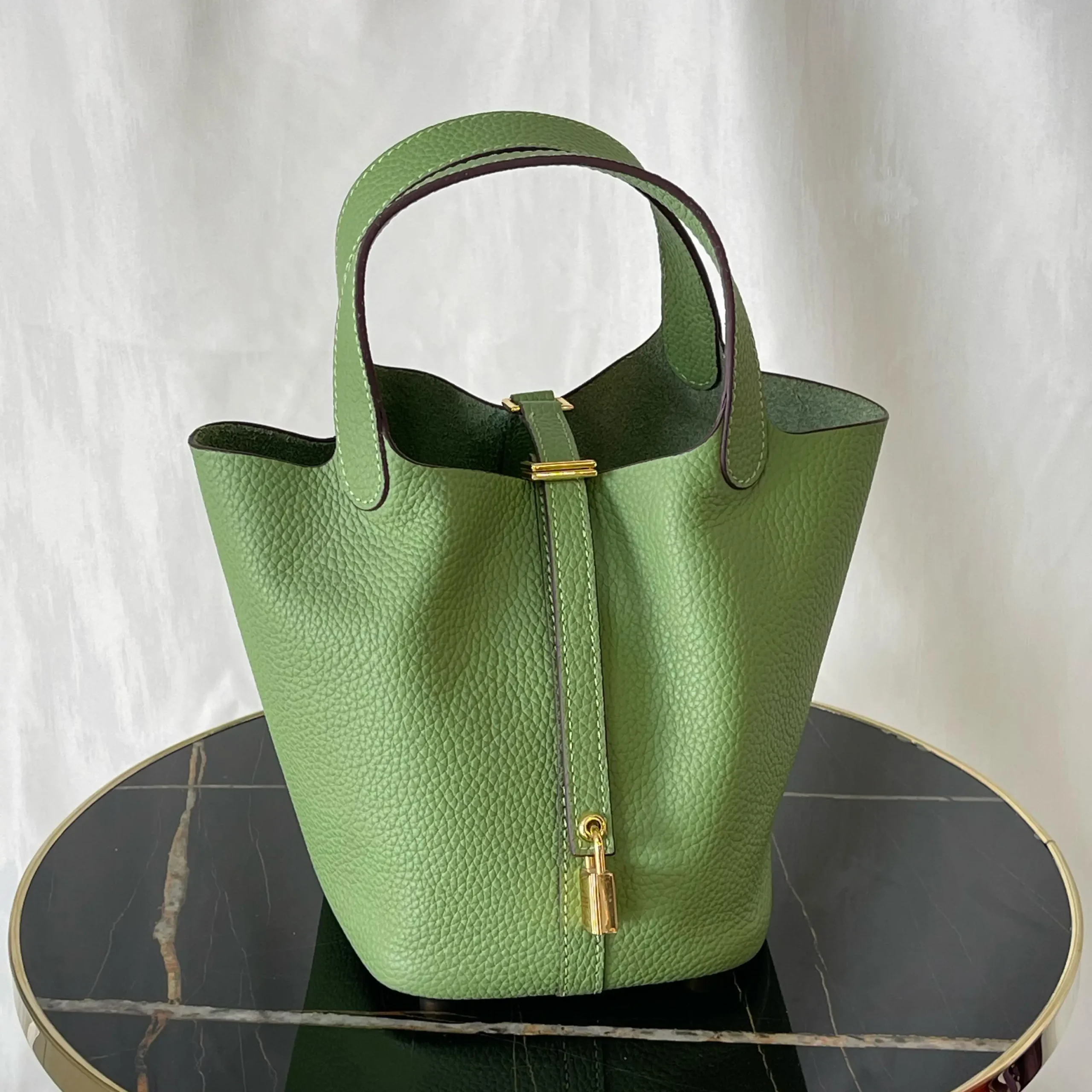 Hermès Picotin Lock 18 in Vert Criquet Clemence Leather – Elegant Bucket Bag with Equestrian Charm in Dubai UAE Hermès Picotin Lock 18 in Vert Criquet Clemence Leather – Elegant Bucket Bag with Equestrian Charm in Dubai UAE